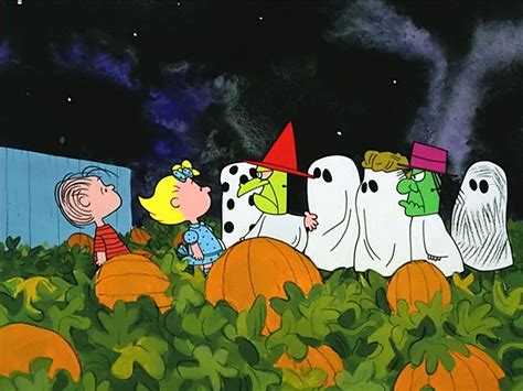 A mysterious picture of the casts of cartoon Peanuts during nighttime outside a house covered in snow, with Charlie Brown at the left and Snoopy leaning on a large pumpkin at the center with the words, Wendys Peanuts Halloween. . Charlie brown halloween desktop wallpaper